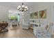 Elegant dining area with stylish furnishings, complemented by natural light and tasteful decor at 5596 Cedar Waxwing Dr, The Villages, FL 32163