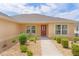 Welcoming front entrance with a decorative door, complemented by neat landscaping and an inviting walkway at 5596 Cedar Waxwing Dr, The Villages, FL 32163