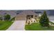 Inviting front yard with lush landscaping and a well-maintained lawn at 5596 Cedar Waxwing Dr, The Villages, FL 32163