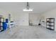 Spacious garage offering ample storage, work tables, and multiple access doors at 5596 Cedar Waxwing Dr, The Villages, FL 32163
