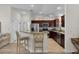 Well-equipped kitchen with dark wood cabinetry, stainless appliances and breakfast bar seating at 5596 Cedar Waxwing Dr, The Villages, FL 32163