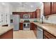 This kitchen features stainless appliances, including refrigerator, range, oven, and dishwasher at 5596 Cedar Waxwing Dr, The Villages, FL 32163