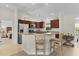 Open kitchen with granite countertops, stainless steel appliances, and a breakfast bar for casual dining at 5596 Cedar Waxwing Dr, The Villages, FL 32163