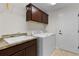 Functional laundry room with countertop, sink, cabinets, and modern washing machine at 5596 Cedar Waxwing Dr, The Villages, FL 32163