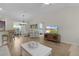 An open concept living room with seamless access to the dining area and kitchen at 5596 Cedar Waxwing Dr, The Villages, FL 32163
