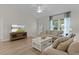 Cozy living room with modern decor, a large window, and comfortable couches at 5596 Cedar Waxwing Dr, The Villages, FL 32163