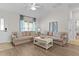 Bright living room with comfortable seating, ceiling fan, and plenty of natural light at 5596 Cedar Waxwing Dr, The Villages, FL 32163