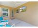 Inviting screened patio with a ceiling fan and a wall-mounted television for entertainment at 5596 Cedar Waxwing Dr, The Villages, FL 32163
