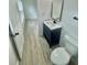 Bathroom with modern vanity, wood-look flooring, and new toilet at 646 Nw 9Th Ave, Webster, FL 33597