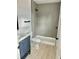 Bathroom features include a tiled shower, vanity, and wood-look flooring at 646 Nw 9Th Ave, Webster, FL 33597