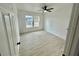 Bright bedroom with light wood floors, ceiling fan, and a double window providing natural light at 646 Nw 9Th Ave, Webster, FL 33597