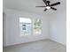 Cozy bedroom with wood-look floors, double windows, and a modern ceiling fan at 646 Nw 9Th Ave, Webster, FL 33597