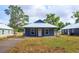 Charming blue home with a metal roof and a well-maintained front yard at 646 Nw 9Th Ave, Webster, FL 33597