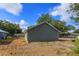 New construction home with green siding and a large backyard ready for landscaping at 646 Nw 9Th Ave, Webster, FL 33597