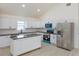 Bright kitchen featuring white cabinets, stainless steel appliances, and a center island at 646 Nw 9Th Ave, Webster, FL 33597