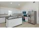 Bright kitchen with stainless steel appliances, island, and white cabinetry at 646 Nw 9Th Ave, Webster, FL 33597