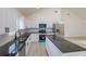Modern kitchen with white cabinetry, stainless steel appliances, and a large island at 646 Nw 9Th Ave, Webster, FL 33597