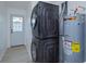 Convenient laundry area with stacked washer/dryer and a water heater at 646 Nw 9Th Ave, Webster, FL 33597