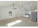 Open-concept living area with high ceilings and ample natural light and a kitchen area at 646 Nw 9Th Ave, Webster, FL 33597