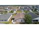 Property view, highlighting the home's backyard, screened lanai, and neighborhood at 744 Shelton St, The Villages, FL 32163
