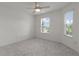 Bright bedroom with neutral walls, plush carpet, and natural light from windows at 744 Shelton St, The Villages, FL 32163