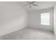 This bedroom features neutral walls, plush carpeting, and natural light from a window at 744 Shelton St, The Villages, FL 32163