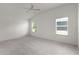 This bright bedroom features neutral walls, plush carpeting, and vaulted ceilings at 744 Shelton St, The Villages, FL 32163