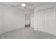 This bedroom features neutral walls, plush carpeting, and closet space at 744 Shelton St, The Villages, FL 32163