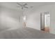 Spacious bedroom with neutral walls, plush carpet and entry to bathroom at 744 Shelton St, The Villages, FL 32163