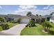 Lovely home showcasing a well-maintained lawn and uniquely designed driveway at 744 Shelton St, The Villages, FL 32163