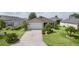 Beautiful home featuring lush landscaping and a custom driveway design at 744 Shelton St, The Villages, FL 32163