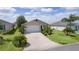 Charming single-story home featuring well-manicured landscaping and a decorative driveway at 744 Shelton St, The Villages, FL 32163