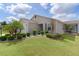 Charming home with well-maintained lawn, manicured landscaping, and beautiful palm trees at 744 Shelton St, The Villages, FL 32163