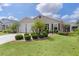Charming home with lush green lawn, manicured landscaping, and palm trees for a tropical feel at 744 Shelton St, The Villages, FL 32163