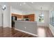 Open kitchen with wood cabinetry and black appliances, connected to the dining area at 744 Shelton St, The Villages, FL 32163