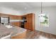 Bright kitchen with wood cabinets, black appliances, and a large window at 744 Shelton St, The Villages, FL 32163