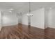 Open-plan living area featuring hardwood floors, white walls, and modern lighting fixture at 744 Shelton St, The Villages, FL 32163