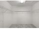A walk-in closet with wire shelving and neutral carpet at 744 Shelton St, The Villages, FL 32163