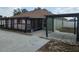 Backyard features a covered patio, mature trees, and concrete details for outdoor enjoyment and relaxation at 8025 Cardinal Winds Ln, Mascotte, FL 34753