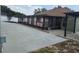 Spacious backyard featuring a covered patio and a concrete walkway, perfect for outdoor living and entertaining at 8025 Cardinal Winds Ln, Mascotte, FL 34753