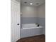 Bathroom featuring a drop-in tub with gray brick-style tile at 8025 Cardinal Winds Ln, Mascotte, FL 34753
