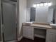 Bathroom with double sinks, vanity, shower, and granite countertops at 8025 Cardinal Winds Ln, Mascotte, FL 34753