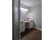 Bathroom with a double sink vanity with granite countertops and modern fixtures at 8025 Cardinal Winds Ln, Mascotte, FL 34753