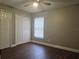 Neutral bedroom features a ceiling fan, a double door closet, and a window with blinds at 8025 Cardinal Winds Ln, Mascotte, FL 34753