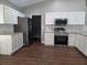 Kitchen featuring stainless steel appliances, granite countertops, and white cabinets at 8025 Cardinal Winds Ln, Mascotte, FL 34753