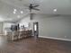 Open living area with island seating, ceiling fan, and plenty of natural light at 8025 Cardinal Winds Ln, Mascotte, FL 34753