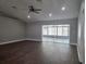 Spacious living room with wood floors, recessed lighting, and sliding glass doors to the outdoors at 8025 Cardinal Winds Ln, Mascotte, FL 34753