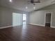 Bright living room features wood floors, recessed lights, and a sliding door to the screened porch at 8025 Cardinal Winds Ln, Mascotte, FL 34753