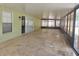 Spacious covered patio featuring large windows, providing an ideal space for outdoor relaxation and entertainment at 8025 Cardinal Winds Ln, Mascotte, FL 34753