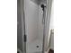 Shower featuring a black rainfall shower head and white tile at 8025 Cardinal Winds Ln, Mascotte, FL 34753